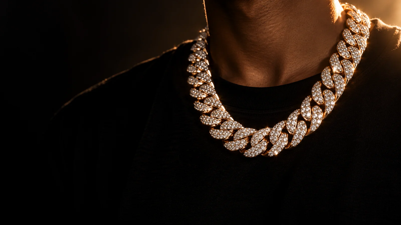 A diamond-set Cuban link chain worn at the neck